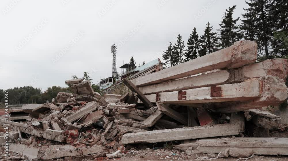 Old broken abandoned sports football stadium with stands and seats. War in Europe between Russia and Ukraine. Military conflict. Destroyed building after missile attack and air strike. Old broken abandoned sports football stadium with stands and seats. War in Europe between Russia and Ukraine. Military conflict. Destroyed building after missile attack and air strike.