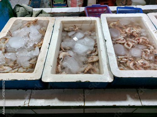 Three boxes of fresh shrimp of different sizes are prepared for visitors at a seafood restaurant.