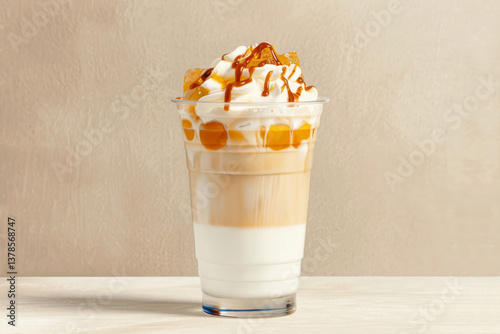 Layered iced caramel macchiato with whipped cream and syrup