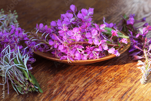 Obraz na płótnie Flower Willowherb Sally bloom on wooden background. Top view. w salonie