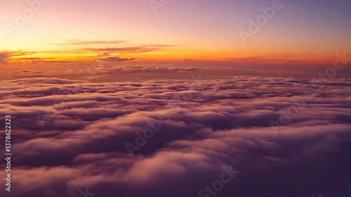 POV flying above clouds in sunset sky