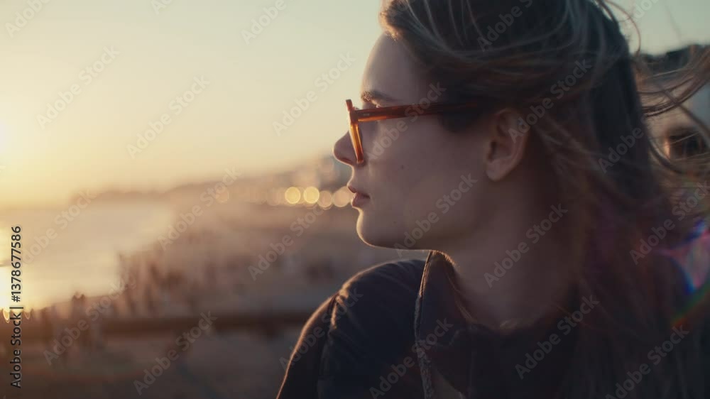 Sunset over Kamakura beach with view of Mt. Fuji as waves crash gently and wind flows through a girl’s hair by the ocean. Sunset over Kamakura beach with view of Mt. Fuji as waves crash gently and wind flows through a girl’s hair by the ocean.