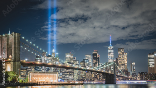 Night view during 9 11 of lower Manhattan and the Brooklyn Bridge with the Tribute in Light in the background