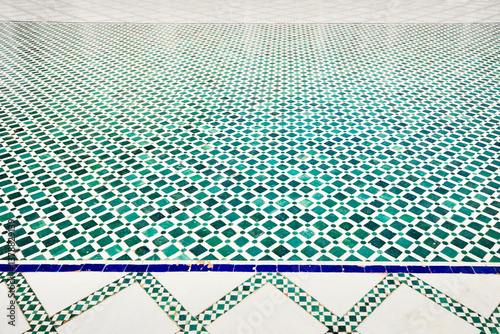 Green and white zellij tiles creating a mesmerizing geometric pattern on a moroccan floor, showcasing the beauty of traditional craftsmanship