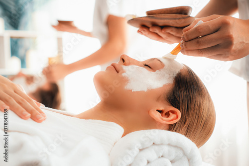 Serene ambiance of spa salon, couple indulges in rejuvenating with luxurious face cream massage with modern daylight. Facial skin treatment and beauty care concept. Quiescent
