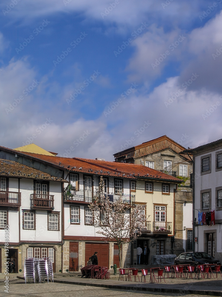 Fototapeta premium Guimaraes, Portugal. Medieval houses in Sao Tiago aka Santiago Square. Historical Center of Guimaraes. Unesco World Heritage Site