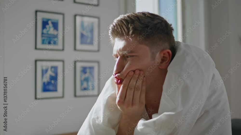 Man making funny grimace in cozy blanket. Closeup happy couple relaxing morning Man making funny grimace in cozy blanket. Closeup happy couple relaxing morning