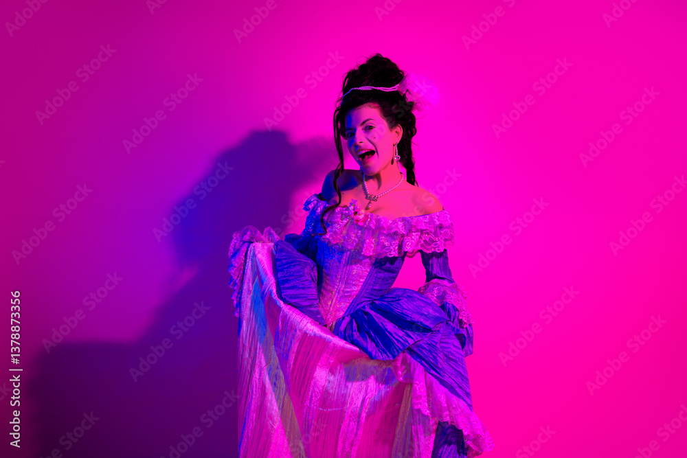 Fototapeta premium Vibrant young woman in a historical costume adorned with vivid colors and elegant details under neon lighting