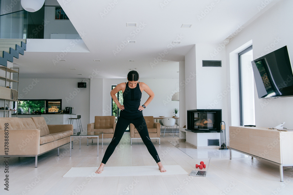 Obraz premium Young Beautiful Female Exercising, Stretching and Practising Yoga with Trainer via Video Call Conference in Bright Sunny House. Healthy Lifestyle, Wellbeing and Mindfulness Concept