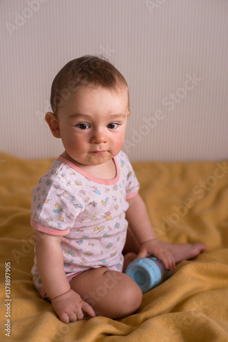 cute baby sitting on the yellow blanket