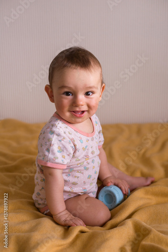 cute baby sitting on the yellow blanket