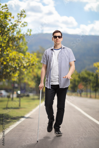 Young blind man walking