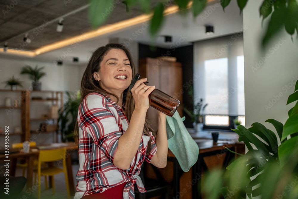 Happy housewife cleaning home and smiling using bio cleaning products Happy housewife cleaning home and smiling using bio cleaning products