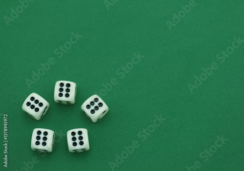 Five white dice arranged on a green surface showing various numb