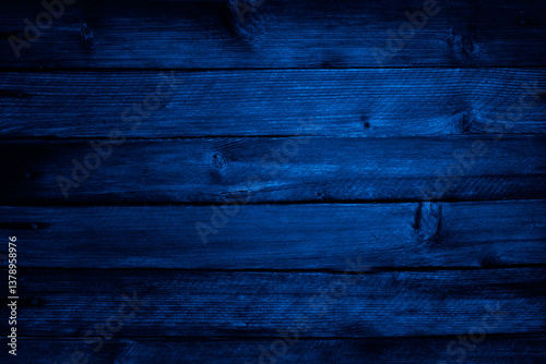 Black dark blue old wooden wall. Close-up. Dark grunge background for design.
