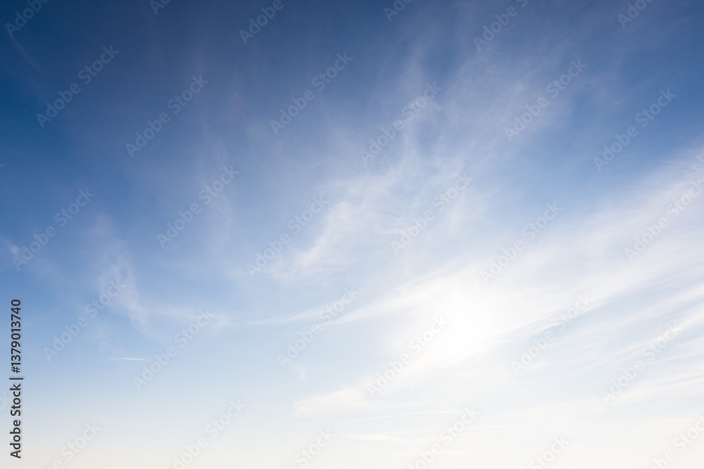 Fototapeta premium A serene image showcasing a clear blue sky adorned with soft, wispy clouds