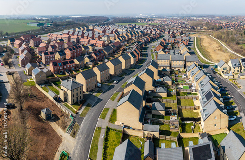 Aerial view of a new build housing estate with characterless houses in a row