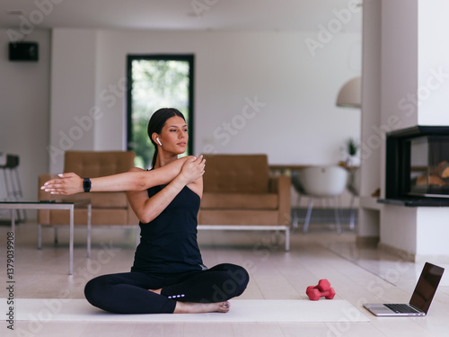 Young Beautiful Female Exercising, Stretching and Practising Yoga with Trainer via Video Call Conference in Bright Sunny House. Healthy Lifestyle, Wellbeing and Mindfulness Concept.