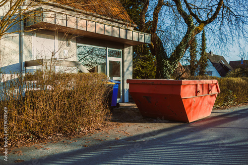 Obraz na płótnie Large metal container for construction waste. Container stands near the house to remove waste after renovation. Removal of construction waste. w salonie
