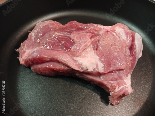 A large piece of turkey meat in a frying pan