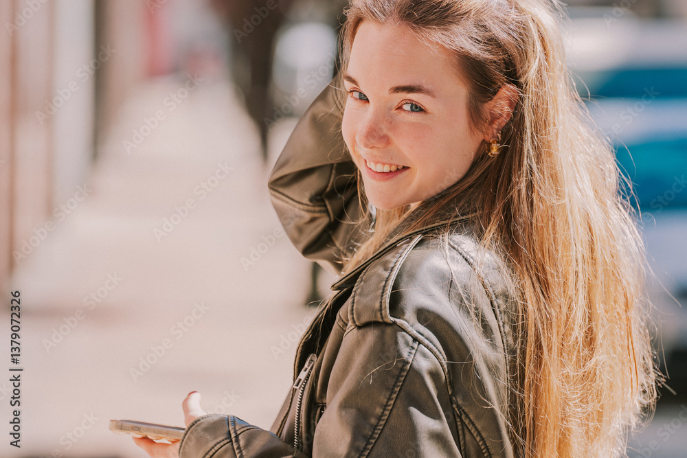 Fototapeta premium long-haired urban blonde girl with mobile phone