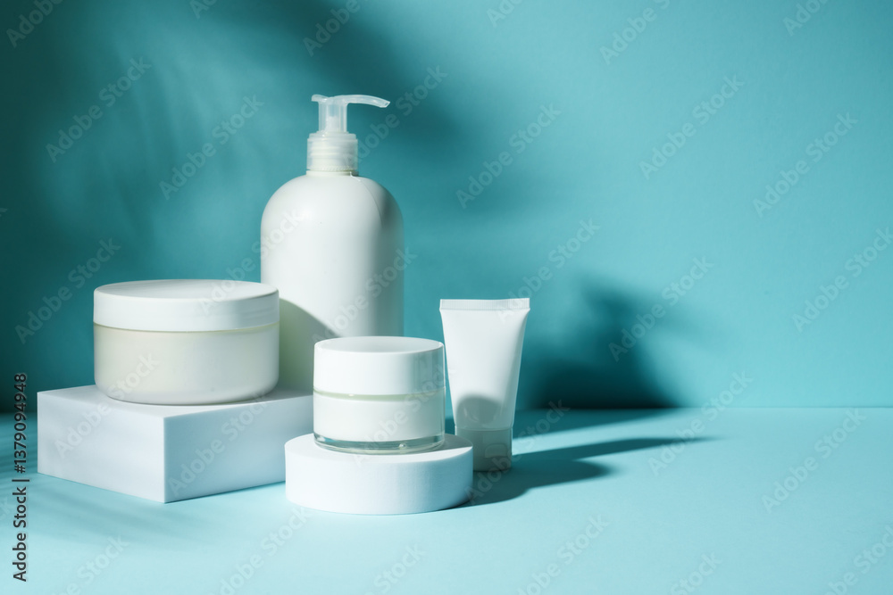 Cosmetic products at podium on blue background.