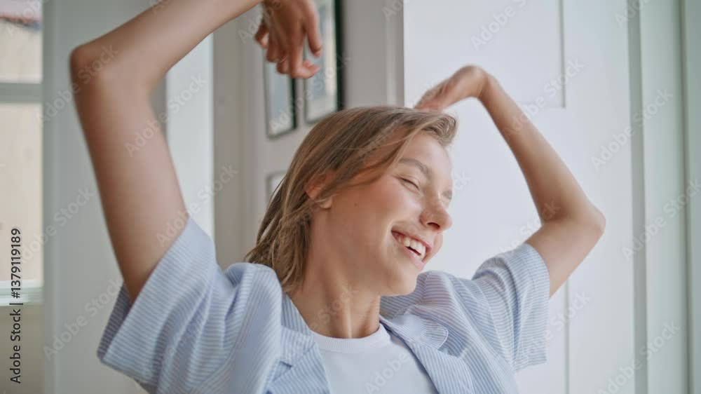 Happy girl stretching arms in morning apartment closeup. Serene woman dreaming Happy girl stretching arms in morning apartment closeup. Serene woman dreaming