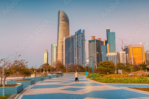 Obraz na płótnie Modern skyscrapers rising above a promenade in Abu Dhabi at sunset w salonie