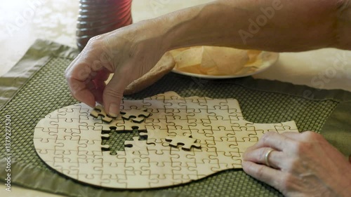 senior having trouble putting the pieces in a brain puzzle