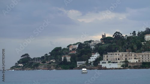 Wallpaper Mural Boat floating on the sea with buildings and trees on the background Torontodigital.ca
