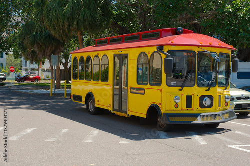 Yellow and red trolley bus Downtown Looper a free service operating in downtown St. Petersburg, Florida. Runs seven days a week with 15 to 20 minute frequency. Providing a car free transportation opti