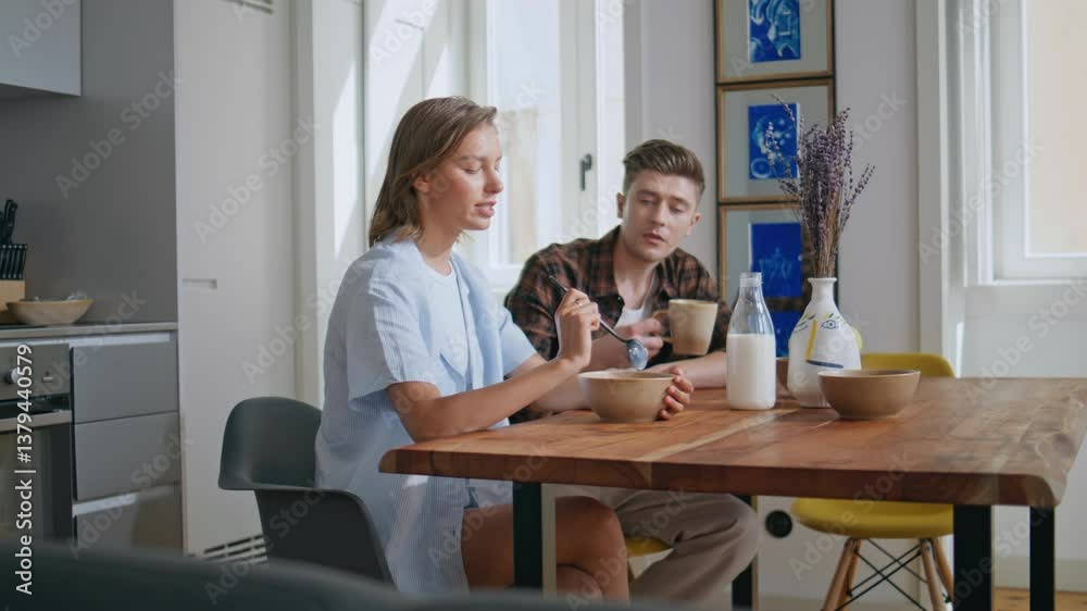 Joyful family enjoying breakfast together. Loving couple talk in sunny morning Joyful family enjoying breakfast together. Loving couple talk in sunny morning