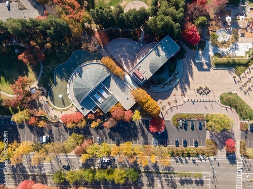 Aerial view of the Ramon Community Center, San Ramon, California, USA, showcasing its unique architecture and surrounding fall foliage. The image captures the center's design with nature.