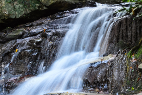 Beautiful small waterfall in green forest