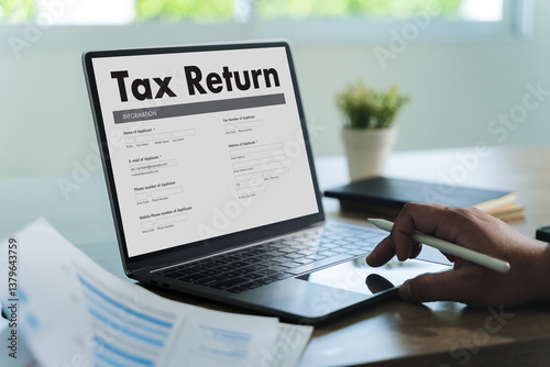 Obraz na płótnie tax return Business person using a laptop Tax season is approaching, and businesses must file their income return online to meet government deadlines, avoid debt, and ensure a refund. w salonie
