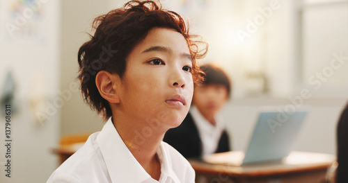 Education, child or thinking in class for learning, daydreaming and distracted in lesson. Japanese boy, face or student in elementary school for development, growth and kid with ADHD in academy
