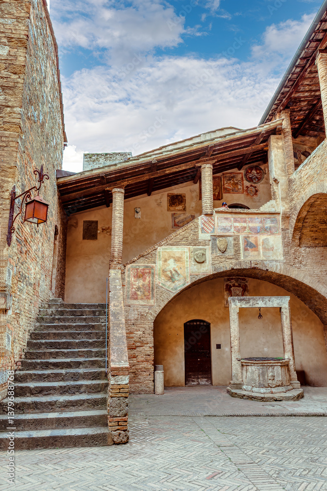 The courtyard with the medieval well of the Palazzo Comunale Palace in the city of San Gimignano in Tuscany.