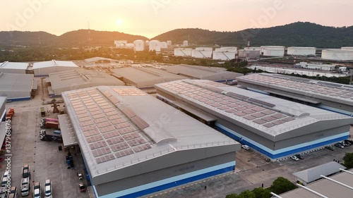 Top view Solar Cell on Warehouse Factory. Solor photo voltaic panels system power or Solar Cell on industrial building roof for producing green ecological electricity. Production of renewable energy.