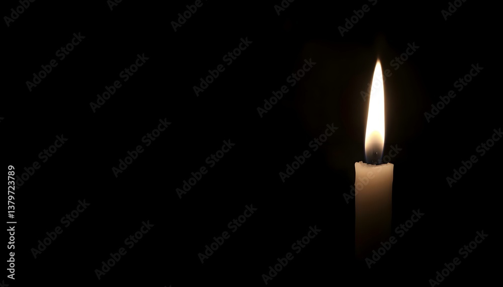 lit candle in the dark with a black background