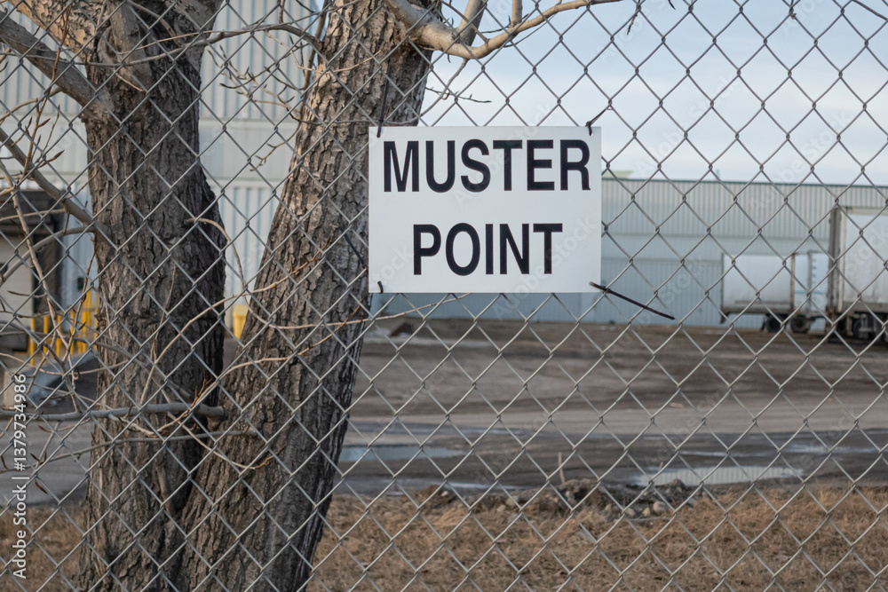 Muster point sign attched to Chain Link Fence
