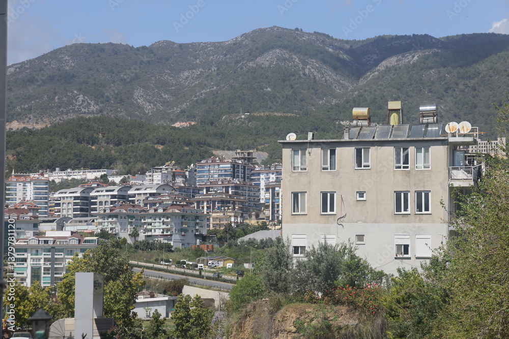 Obraz premium Residential buildings on green hillsides, Upper Oba, Alanya, Turkey, March 2025, 2