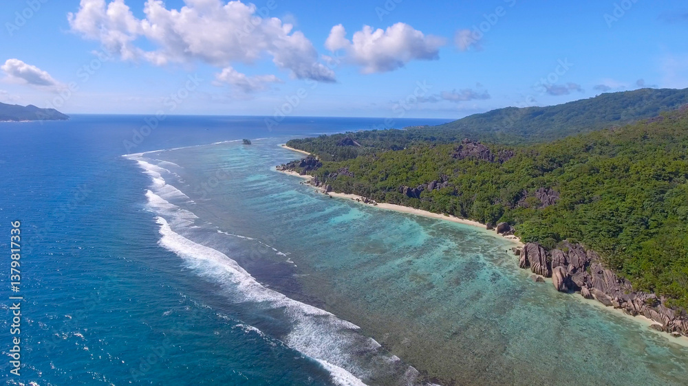 Anse Source D'Argent Beach in La Digue, Seychelles. Aerial view of tropical coastline on a sunny day