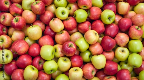 A high-angle close-up view of a large pile of fresh red and green apples.