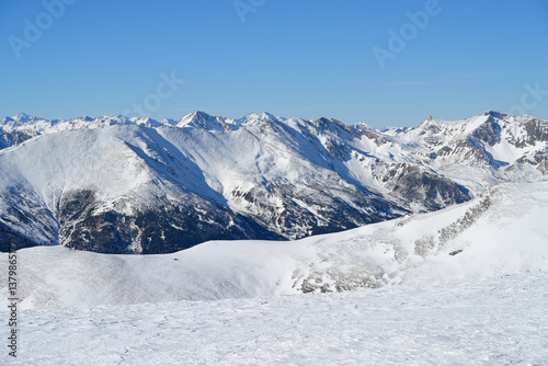 Cloudless blue sky above sunny winter mountain panorama landscape. Seen during a ski hike in the Lachtal to the summit Schießeck, Styria