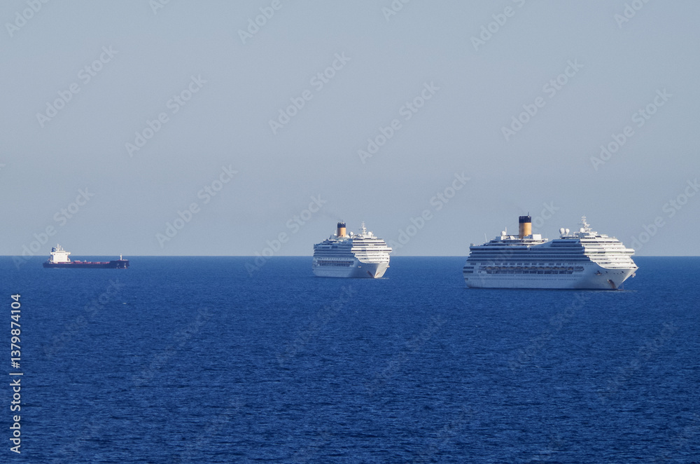Mega family cruiseship cruise ship liners Favolosa and Fortuna anchored offshore of Civitavecchia Rome, Italy before reactived after Covid pandemic with other vessels in port and coastline