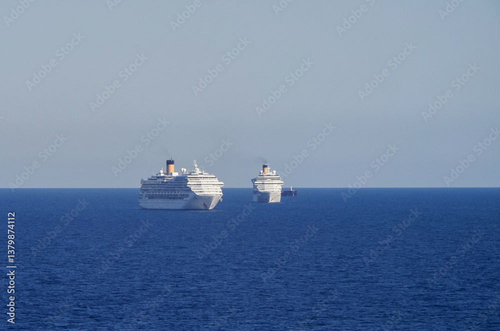 Mega family cruiseship cruise ship liners Favolosa and Fortuna anchored offshore of Civitavecchia Rome, Italy before reactived after Covid pandemic with other vessels in port and coastline