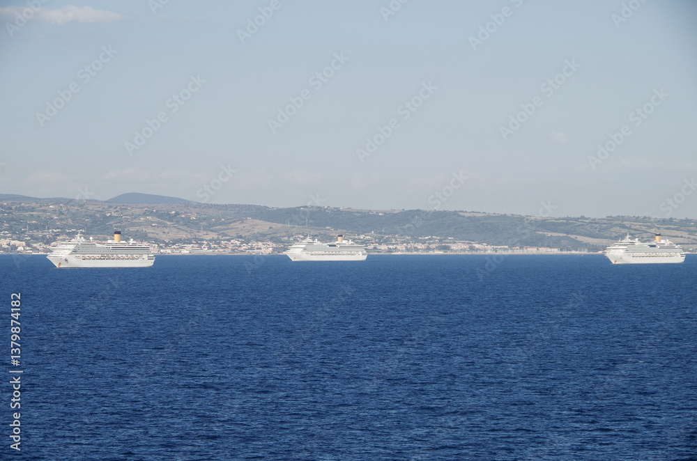 Mega family cruiseship cruise ship liners Favolosa and Fortuna anchored offshore of Civitavecchia Rome, Italy before reactived after Covid pandemic with other vessels in port and coastline