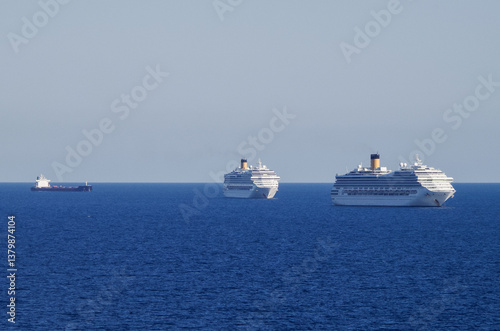 Obraz na płótnie Mega family cruiseship cruise ship liners Favolosa and Fortuna anchored offshore of Civitavecchia Rome, Italy before reactived after Covid pandemic with other vessels in port and coastline w salonie