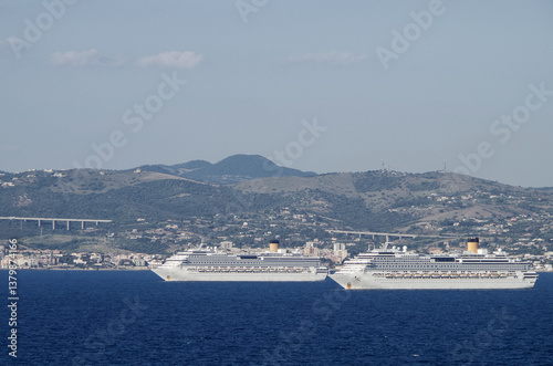 Obraz na płótnie Mega family cruiseship cruise ship liners Favolosa and Fortuna anchored offshore of Civitavecchia Rome, Italy before reactived after Covid pandemic with other vessels in port and coastline w salonie