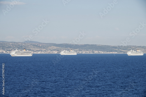 Obraz na płótnie Mega family cruiseship cruise ship liners Favolosa and Fortuna anchored offshore of Civitavecchia Rome, Italy before reactived after Covid pandemic with other vessels in port and coastline w salonie